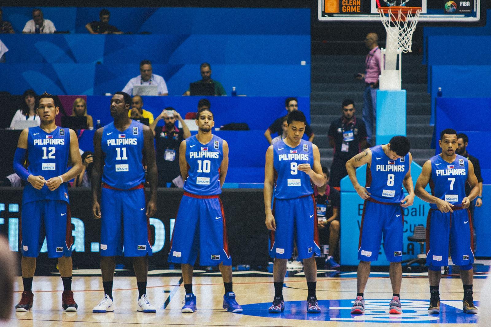 Philippine national team players in blue Pilipinas jerseys lined up on court at a FIBA World Cup game