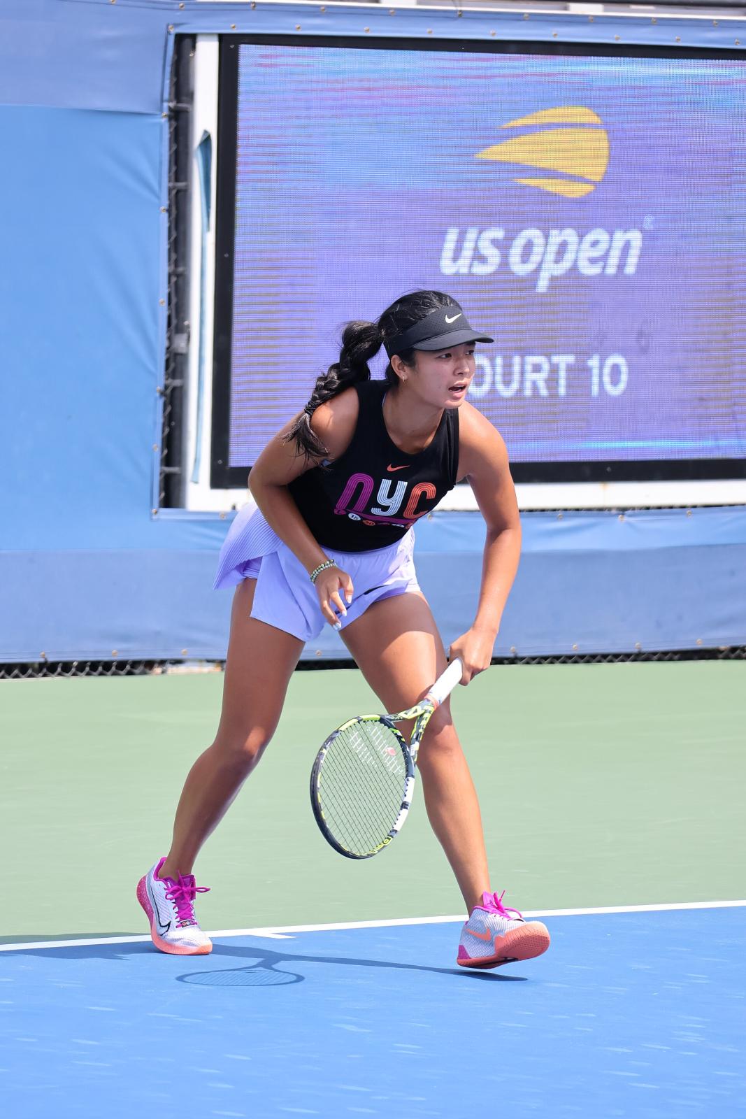 Alex Eala in a practice session at the 2024 US Open, mid-forehand on a blue hard court